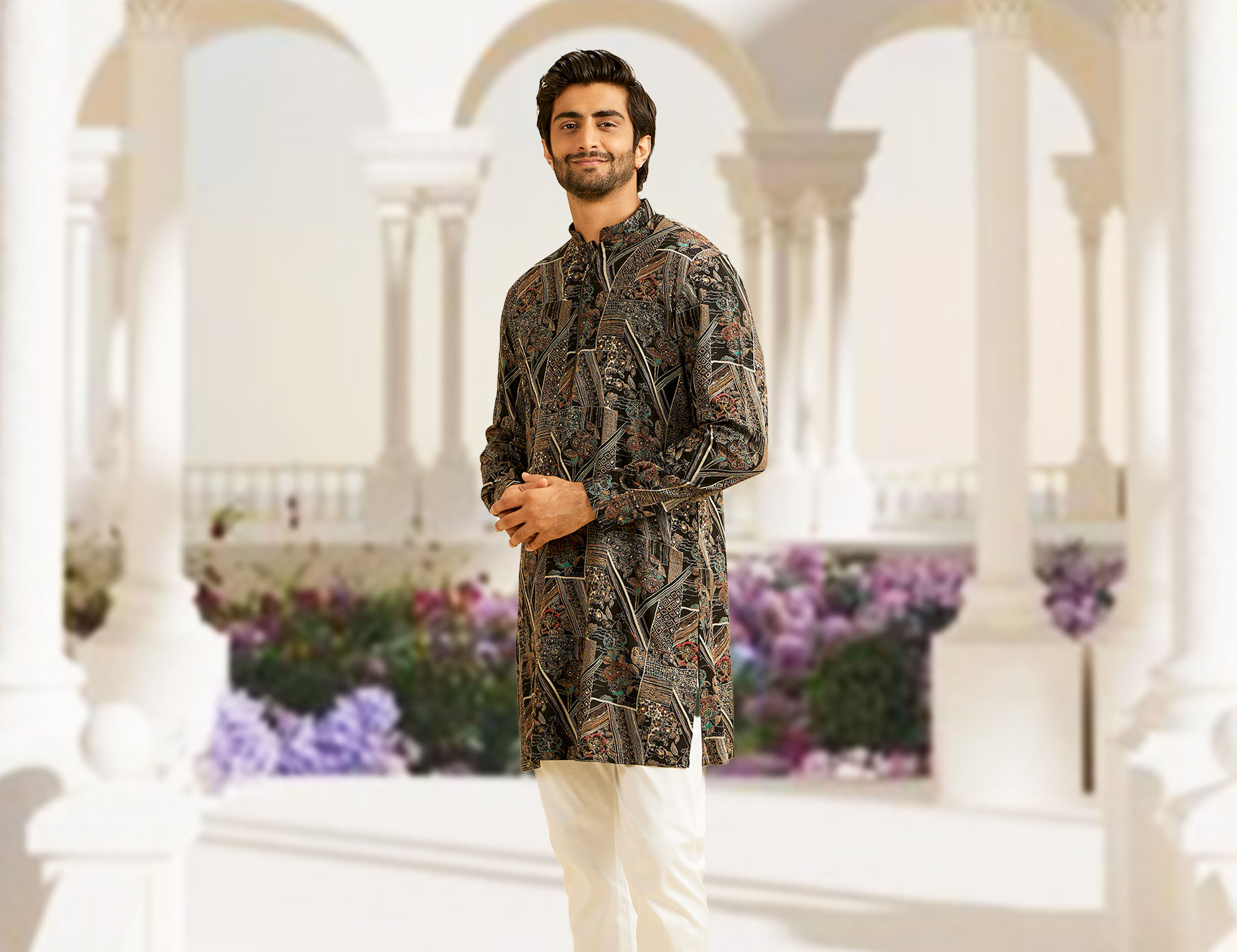 Man in a beautifully patterned kurta showcasing intricate print designs.